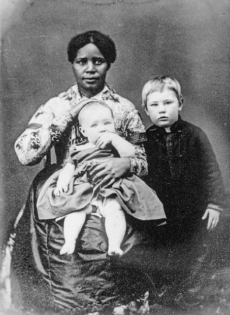 beyond vanity elizabeth block: Young Black female nanny, seated, with a baby on her lap and young boy standing, albumen on card mount, The Library Company of Philadelphia, Philadelphia, PA, USA. Elizabeth L. Block, Beyond Vanity, The History and Power of Hairdressing, 2024, MIT Press.
