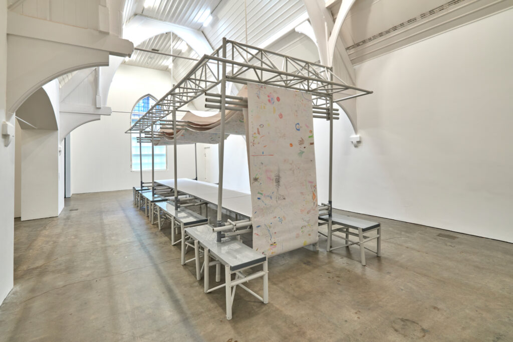 Friends in Love and War: Niek van de Steeg, Structure de correction, table de débat, ca. 2000, as exhibited in Friends in Love and War—L’Éloge des meilleur·es ennemi·es, Ikon Gallery, installation view, 2024. Image courtesy Ikon. Photo by David Rowan.
