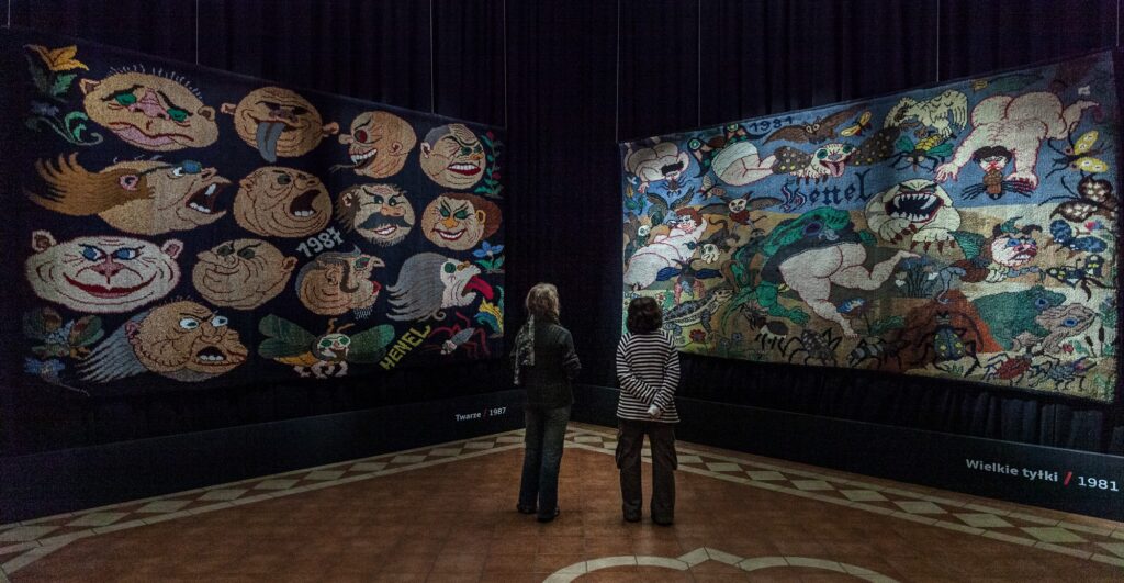 Marian Henel: Exhibition view. From the left: Marian Henel, Faces, 1987, 260 × 485 cm; Big Butts, 1981, 240 × 480 cm, Specialized Hospital of Bishop Józef Nathan, Branice, Poland. Photo by W. Rogowicz, National Museum in Wrocław.
